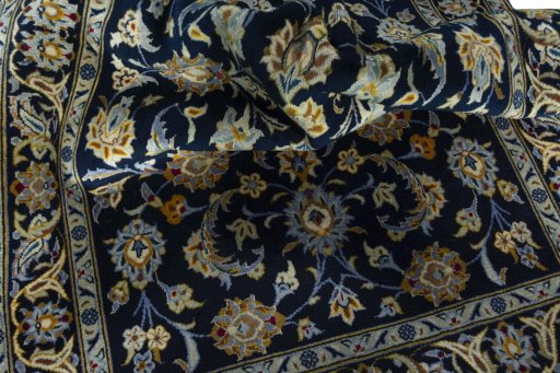 Close-up detail of 2000s Kashan rug from Iran / Persia showing Wool weave