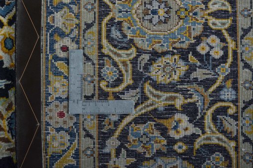 Backside of handmade 2000s Kashan rug showing knot structure and weave density