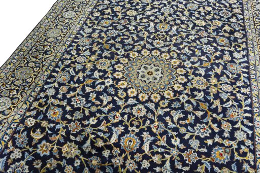 Backside of handmade 2000s Kashan rug showing knot structure and weave density