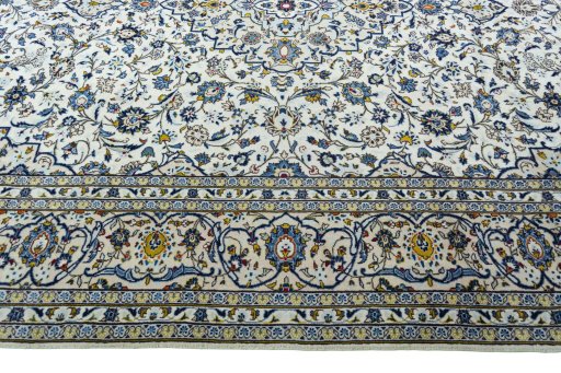 Corner detail of 2000s Kashan rug showing border pattern and Wool pile