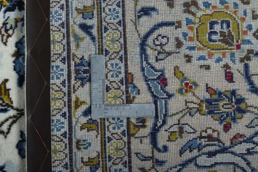 Backside of handmade 2000s Kashan rug showing knot structure and weave density