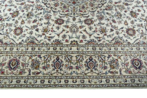 Corner detail of 2000s Kashan rug showing border pattern and Wool pile