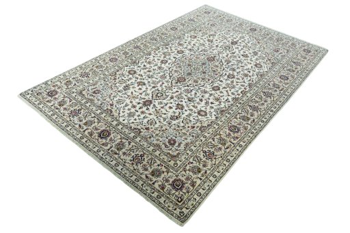 Corner detail of 2000s Kashan rug showing border pattern and Wool pile