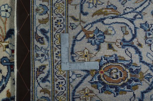 Backside of handmade 2000s Kashan rug showing knot structure and weave density