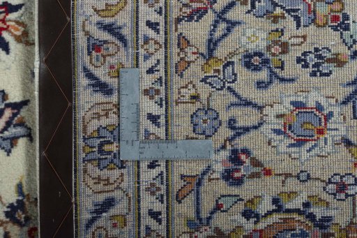Backside of handmade 2000s Kashan rug showing knot structure and weave density