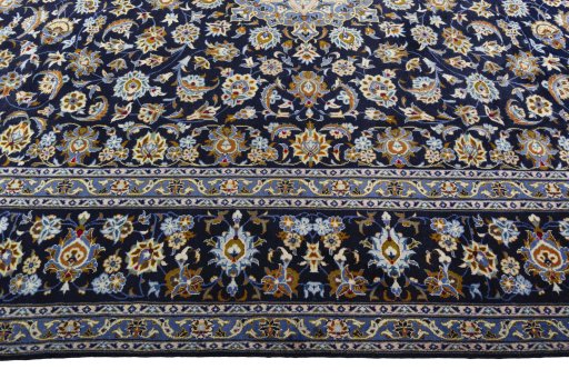 Corner detail of 2000s Kashan rug showing border pattern and Wool pile