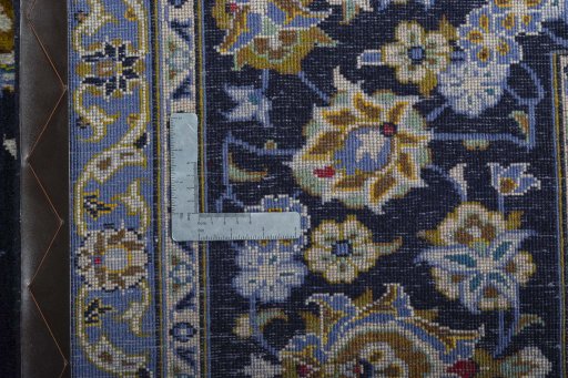 Backside of handmade 2000s Kashan rug showing knot structure and weave density