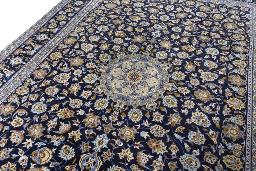Backside of handmade 2000s Kashan rug showing knot structure and weave density