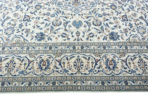 Corner detail of 2000s Kashan rug showing border pattern and Wool pile