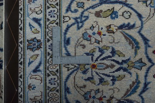 Backside of handmade 2000s Kashan rug showing knot structure and weave density