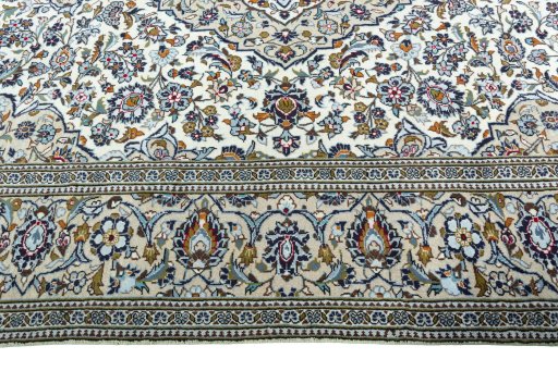 Corner detail of 2000s Kashan rug showing border pattern and Wool pile