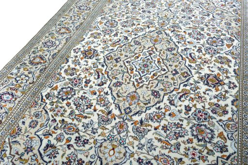 Backside of handmade 2000s Kashan rug showing knot structure and weave density