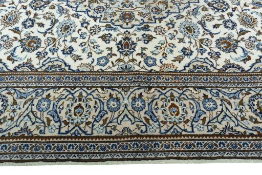 Corner detail of 2000s Kashan rug showing border pattern and Wool pile
