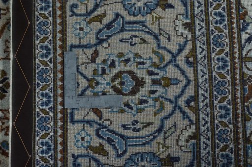 Backside of handmade 2000s Kashan rug showing knot structure and weave density