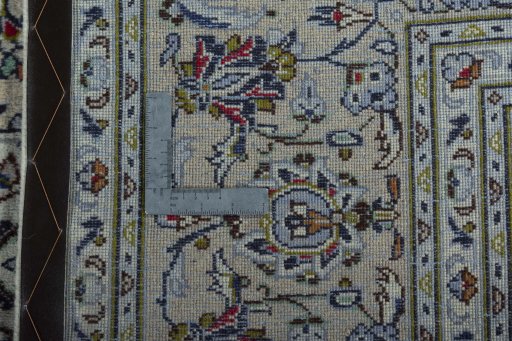 Backside of handmade 2000s Kashan rug showing knot structure and weave density