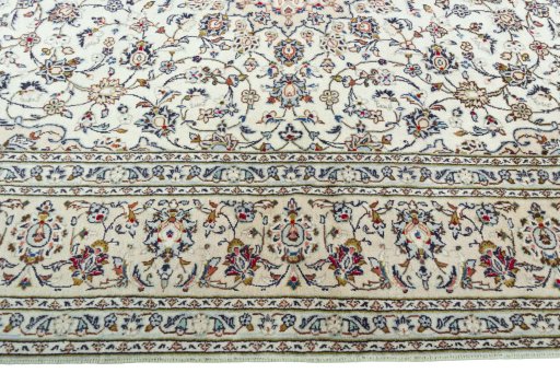 Corner detail of 2000s Kashan rug showing border pattern and Wool pile