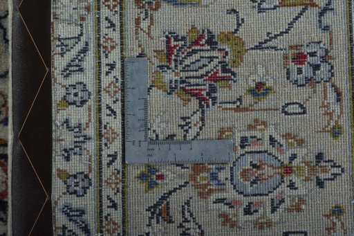 Backside of handmade 2000s Kashan rug showing knot structure and weave density