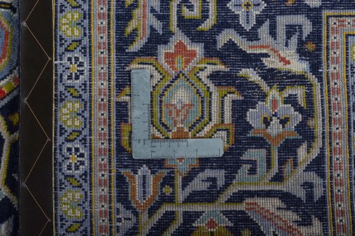 Backside of handmade 2000s Kashan rug showing knot structure and weave density