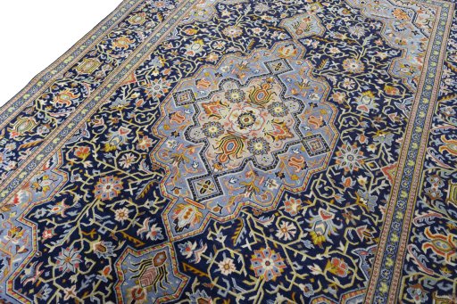 Backside of handmade 2000s Kashan rug showing knot structure and weave density