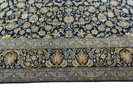 Corner detail of 2000s Kashan rug showing border pattern and Wool pile