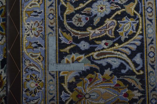 Backside of handmade 2000s Kashan rug showing knot structure and weave density