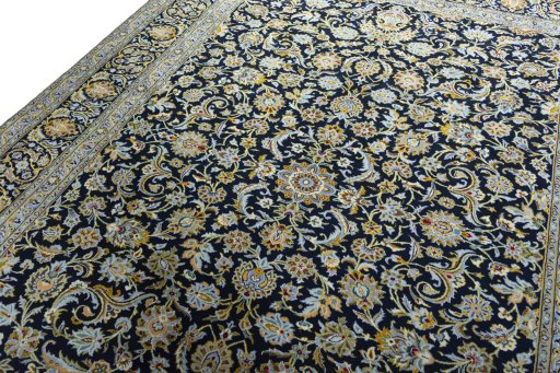 Backside of handmade 2000s Kashan rug showing knot structure and weave density