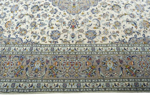 Corner detail of 2000s Kashan rug showing border pattern and Wool pile