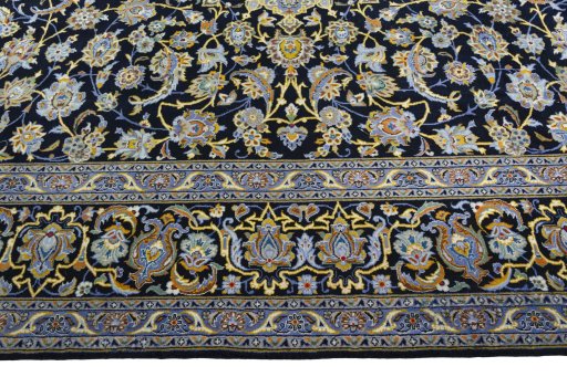 Corner detail of 2000s Kashan rug showing border pattern and Wool pile