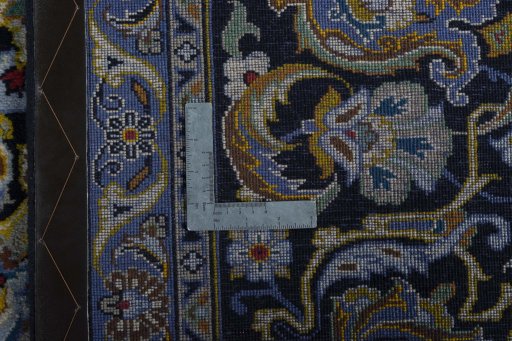 Backside of handmade 2000s Kashan rug showing knot structure and weave density