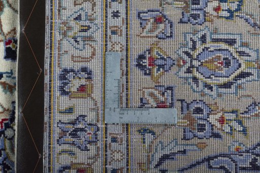 Backside of handmade 2000s Kashan rug showing knot structure and weave density