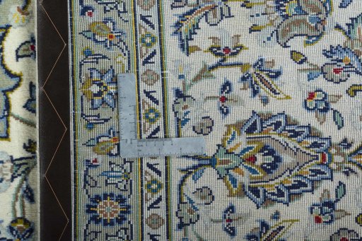Backside of handmade 2000s Kashan rug showing knot structure and weave density