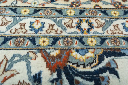 Backside of handmade 2000s Kashan rug showing knot structure and weave density