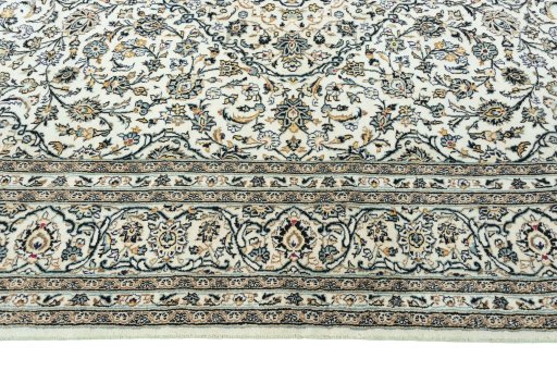 Corner detail of 2000s Kashan rug showing border pattern and Wool pile