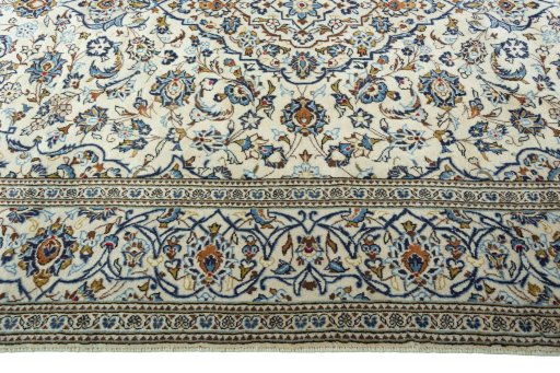 Corner detail of 2000s Kashan rug showing border pattern and Wool pile