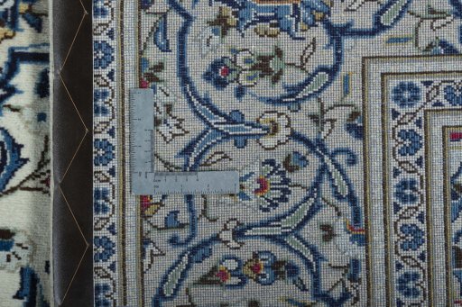 Backside of handmade 2000s Kashan rug showing knot structure and weave density