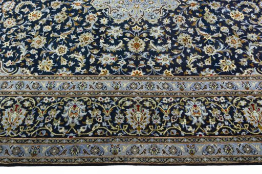 Corner detail of 2000s Kashan rug showing border pattern and Wool pile