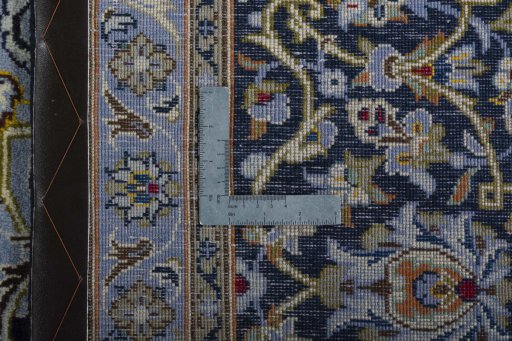 Backside of handmade 2000s Kashan rug showing knot structure and weave density
