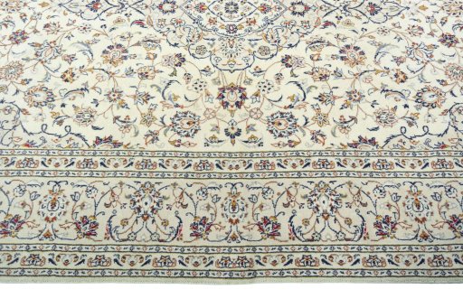 Corner detail of 2000s Kashan rug showing border pattern and Wool pile