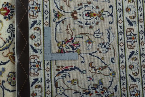 Backside of handmade 2000s Kashan rug showing knot structure and weave density