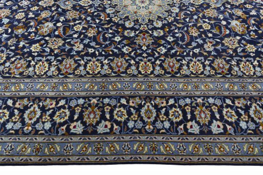 Corner detail of 2000s Kashan rug showing border pattern and Wool pile