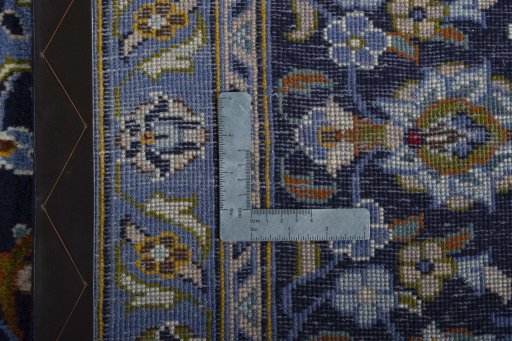 Backside of handmade 2000s Kashan rug showing knot structure and weave density