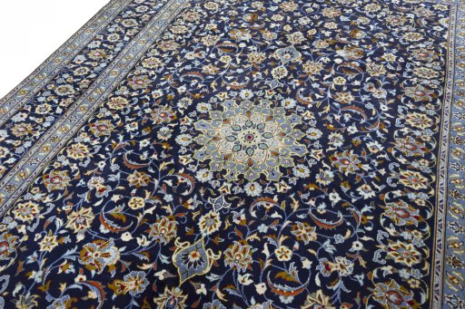 Backside of handmade 2000s Kashan rug showing knot structure and weave density