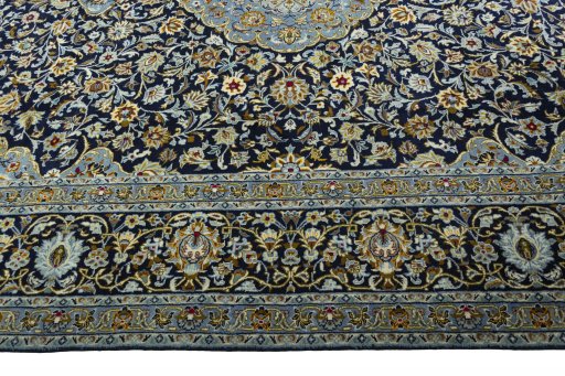 Corner detail of 2000s Kashan rug showing border pattern and Wool pile