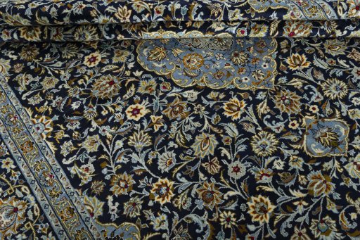 Close-up detail of 2000s Kashan rug from Iran / Persia showing Wool weave