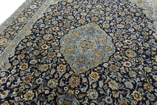 Backside of handmade 2000s Kashan rug showing knot structure and weave density