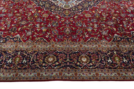 Corner detail of 2000s Kashan rug showing border pattern and Cork pile