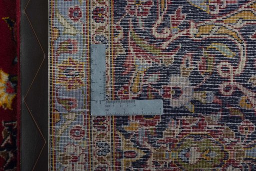 Backside of handmade 2000s Kashan rug showing knot structure and weave density
