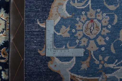 Backside of handmade 2000s Kashan rug showing knot structure and weave density