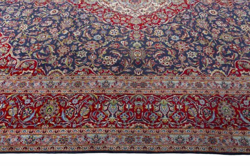 Corner detail of 2000s Kashan rug showing border pattern and Cork pile
