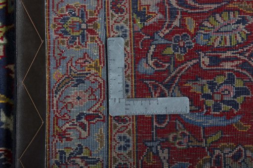 Backside of handmade 2000s Kashan rug showing knot structure and weave density